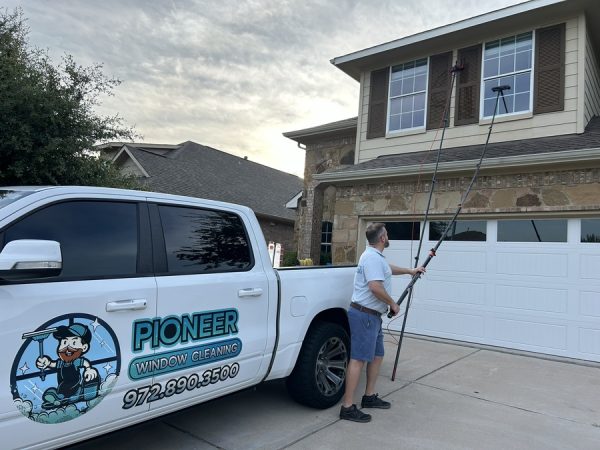 Pioneer technician working on the sun-facing windows of a Central Texas home